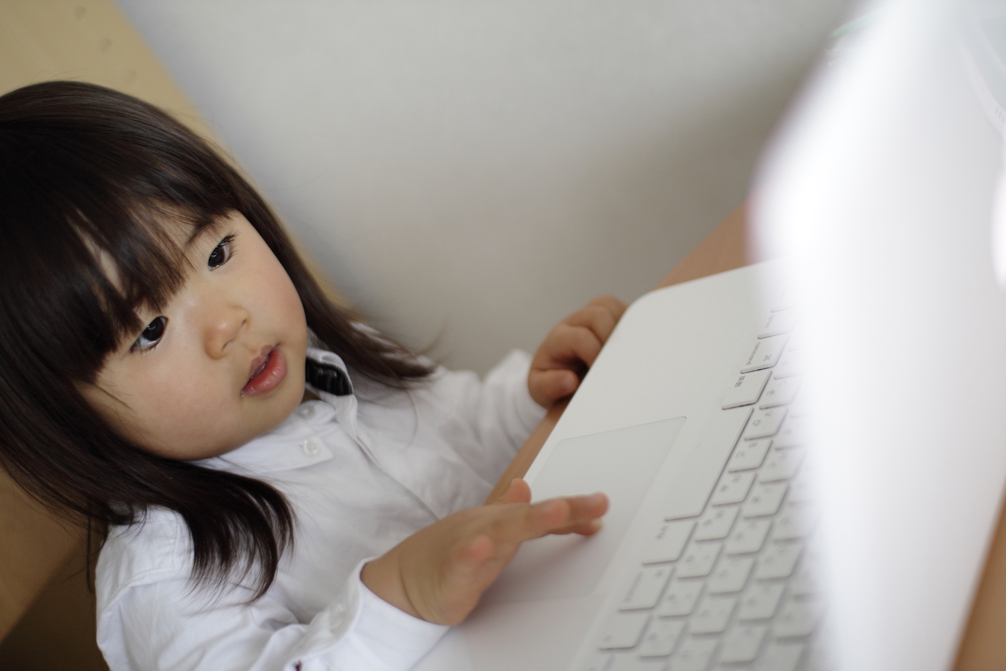 little-girl-using-macbook-white.jpg