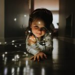 Shot-on-iPhone-holiday-Little-girl-with-string-lights-12192018.jpg